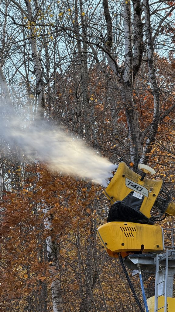 A close up of a yellow snowmaking fan gun