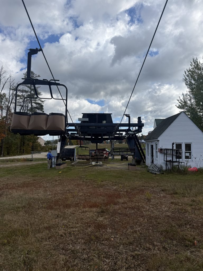 A chairlift with boxes on the chairs