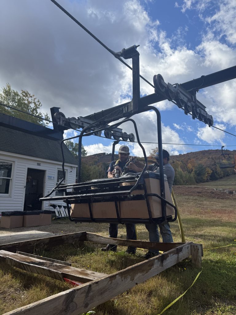 A chairlift with mountains in the background