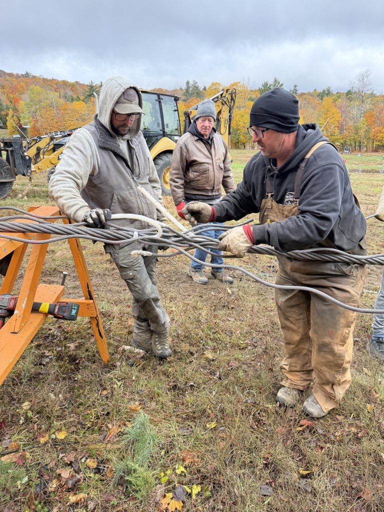 Workers wrapping a cable