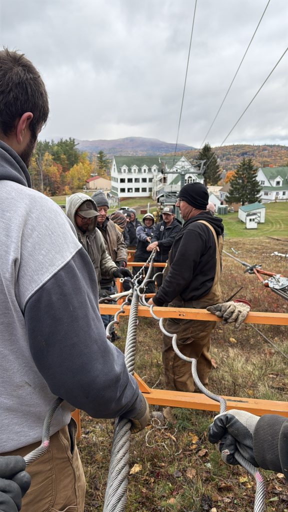 A team works to wrap a steel cable